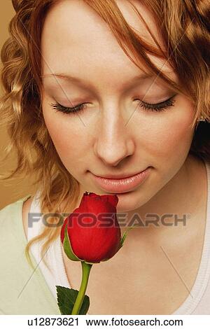 A young adult smelling a red rose View Large Photo Image Stock Image - A young adult smelling a red rose. Fotosearch