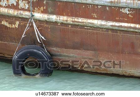 An old boat sitting in the water View Large Photo Image Stock Photo - An old boat sitting in the water. Fotosearch
