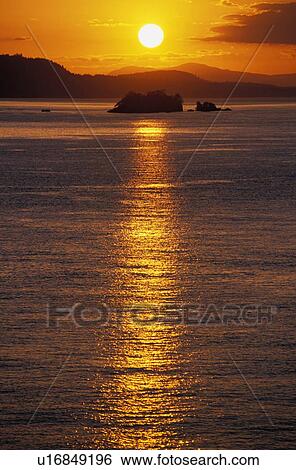 Stock Photograph - Beautiful sunset over water. Fotosearch