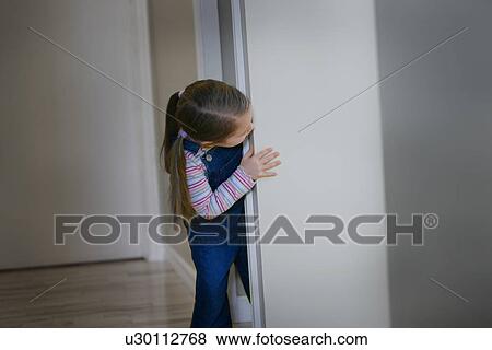Child peeks around a corner View Large Photo Image Stock Photo - Child peeks around a corner. Fotosearch