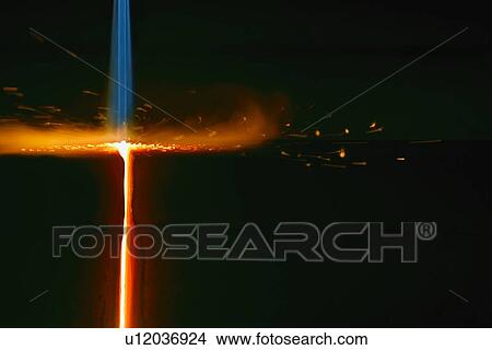 Picture - Closeup of flame cutting a bar of steel. Fotosearch