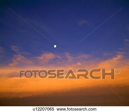 Stock Photography - Evening clouds and Moon. Fotosearch