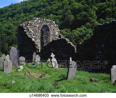 Stock Image - Gravestones and ruins, historic Glendalough Monastery. Fotosearch