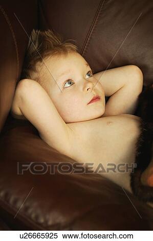 Little boy on couch View Large Photo Image Stock Photography - Little boy on couch. Fotosearch