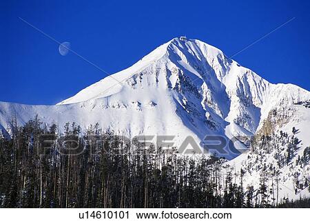 Stock Image - Lone Peak with moon overhead. Fotosearch