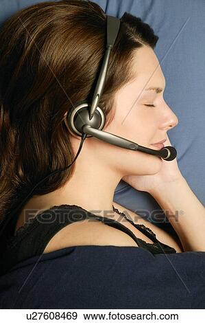 Profile of woman sleeping with headset View Large Photo Image Stock Photo - Profile of woman sleeping with headset. Fotosearch