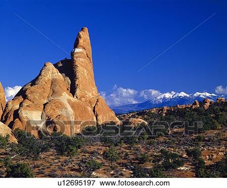 Stock Photo - Red sandstone formations and distant La Sal Mountains, Arches National Park. Fotosearch