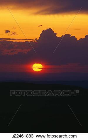 Setting sun behind dark cloud View Large Photo Image Stock Image - Setting sun behind dark cloud. Fotosearch