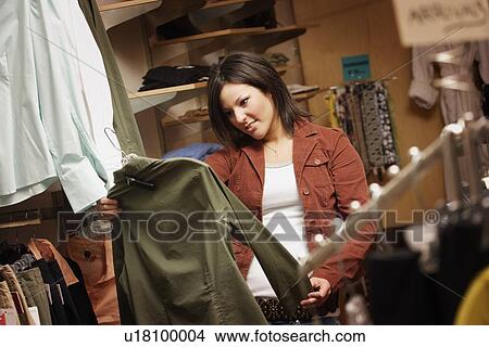 Shopper looking at clothing View Large Photo Image Picture - Shopper looking at clothing. Fotosearch