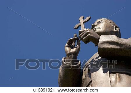 Statue holding a cross View Large Photo Image Stock Image - Statue holding a cross. Fotosearch