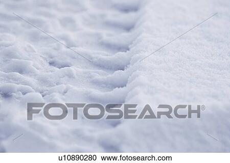 Stock Image - Tire track in snow. Fotosearch