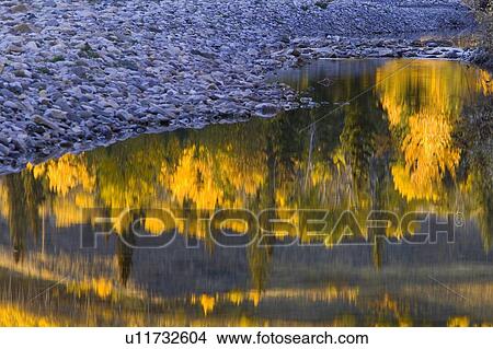 Water reflections with a rocky shoreline View Large Photo Image Picture - Water reflections with a rocky shoreline. Fotosearch