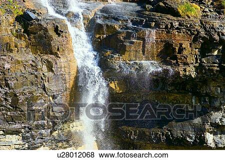 Waterfall cascading over cliff View Large Photo Image Stock Photo - Waterfall cascading over cliff. Fotosearch