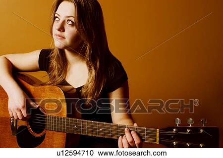 Stock Image - Woman playing guitar. Fotosearch