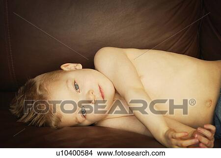 Picture - Young boy lying down. Fotosearch