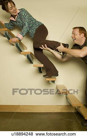 Young Couple Playing on stairs View Large Photo Image Stock Photo - Young Couple Playing on stairs. Fotosearch