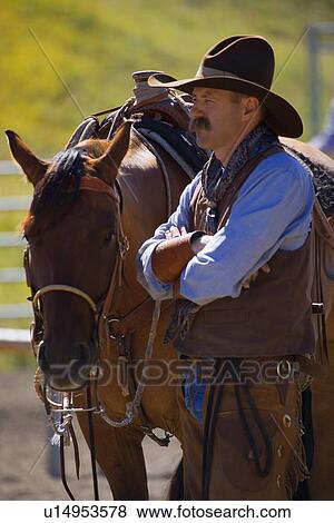 Stock Photo - A cowboy and his horse. Fotosearch