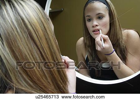 Stock Image - Applying lipstick. Fotosearch