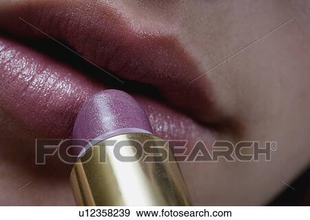 Applying lipstick View Large Photo Image Stock Photo - Applying lipstick. Fotosearch