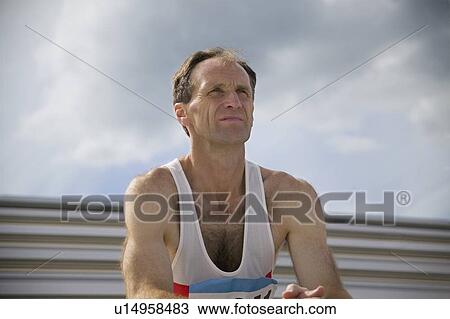 Stock Image - Athlete watches from the bleachers. Fotosearch