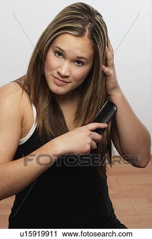Stock Image - Brushing hair. Fotosearch