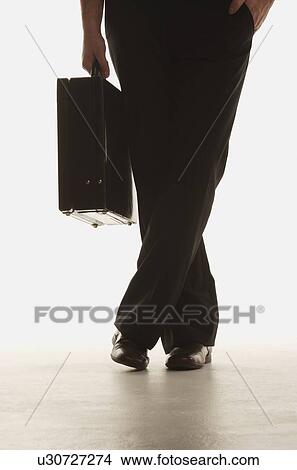 Businessman with briefcase View Large Photo Image Picture - Businessman with briefcase. Fotosearch