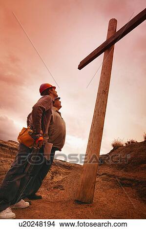 Picture - Carpenters look at the cross. Fotosearch