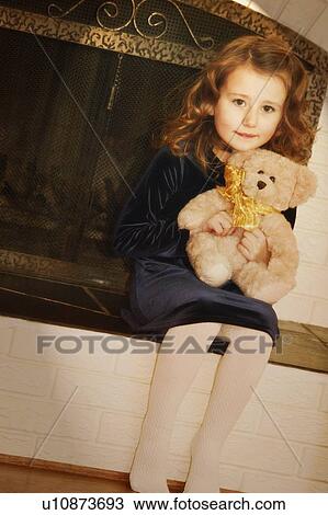 Stock Image - Child holds teddy bear. Fotosearch