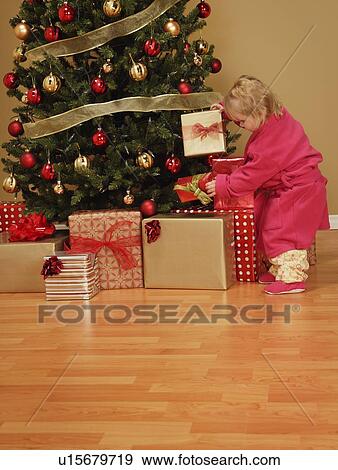 Child looking at presents View Large Photo Image Stock Photo - Child looking at presents. Fotosearch