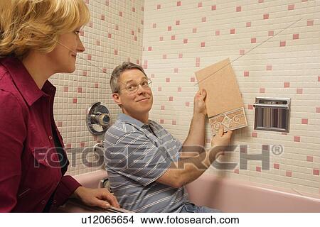 Picture - Choosing new tile. Fotosearch