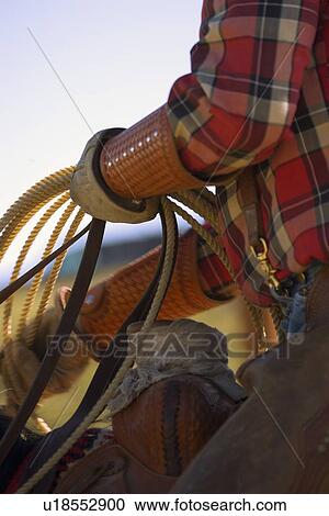 Stock Image - Closeup of cowboy with lasso. Fotosearch