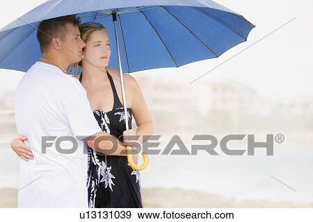 Couple with an umbrella View Large Photo Image Stock Photo - Couple with an umbrella. Fotosearch