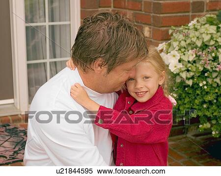 Stock Photography - Daughter hugs father. Fotosearch