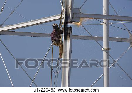 Dismantling of a water tower with cutting torch View Large Photo Image Stock Image - Dismantling of a water tower with cutting torch. Fotosearch