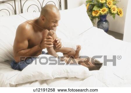 Father plays with baby View Large Photo Image Stock Photo - Father plays with baby. Fotosearch