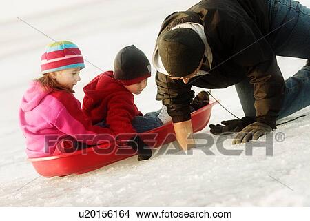 Picture - Father with children on ice. Fotosearch