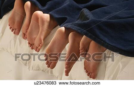 Stock Image - Feet in bed. Fotosearch