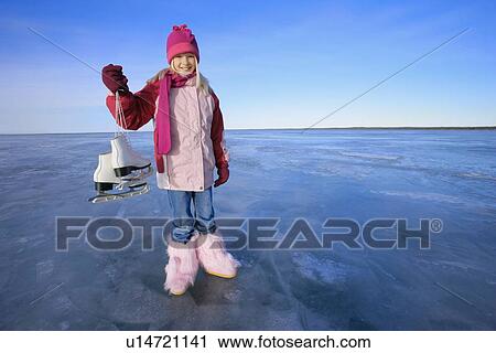 Stock Image - Girl holds skates. Fotosearch