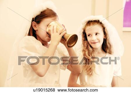 Stock Photo - Girls take first communion. Fotosearch
