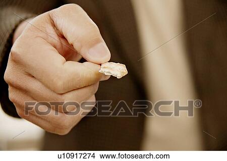 Picture - Holding communion bread. Fotosearch