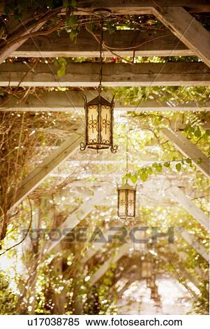 Stock Photography - Lantern hanging from an arbour. Fotosearch