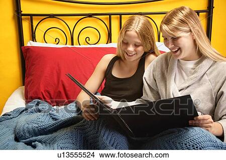 Looking through a photo album View Large Photo Image Picture - Looking through a photo album. Fotosearch
