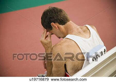 Stock Photo - Male athlete sitting. Fotosearch