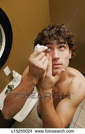 Man putting in eye drops View Large Photo Image Picture - Man putting in eye drops. Fotosearch