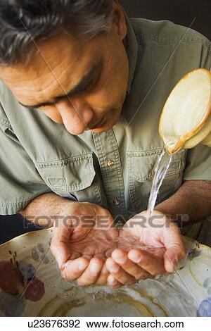 Stock Image - Man washing his hands. Fotosearch
