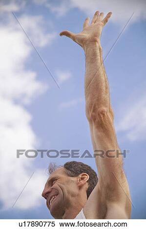 Stock Photography - Man with arm raised. Fotosearch