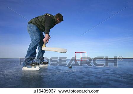Stock Photo - Playing hockey solo. Fotosearch