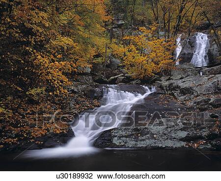 Stock Image - Robinson River cascade through a vivid autumnal canyon. Fotosearch