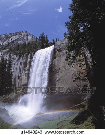 Stock Image - Rushing waters of Vernal Falls with rainbow. Fotosearch