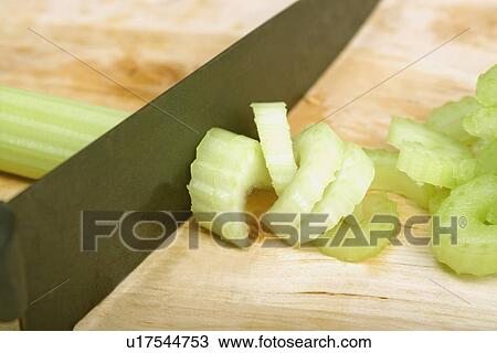 Stock Image - Slicing celery. Fotosearch
